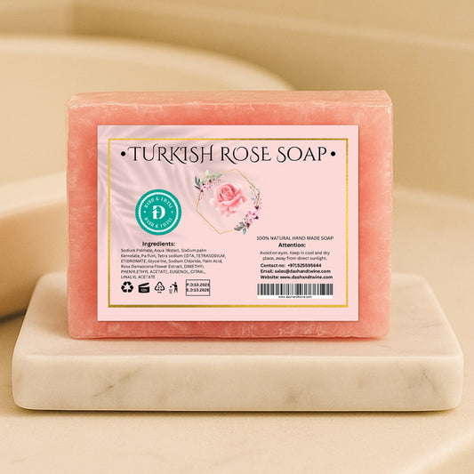 Turkish rose pink handmade soap bar with floral label, wrapped in clear plastic and placed on a white surface