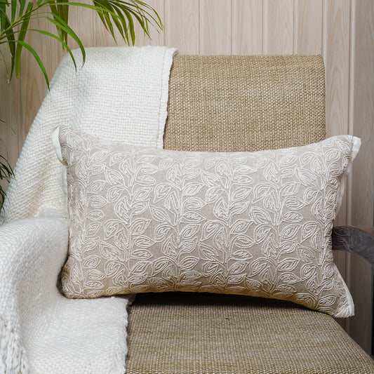 Neutral-toned rectangular cushion with white thread leaf embroidery on chambray fabric