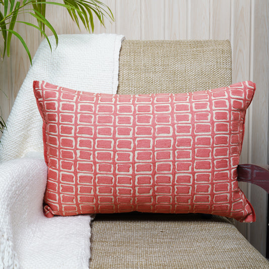 Hand-embroidered rectangular cushion with rose blush geometric design on a neutral beige background