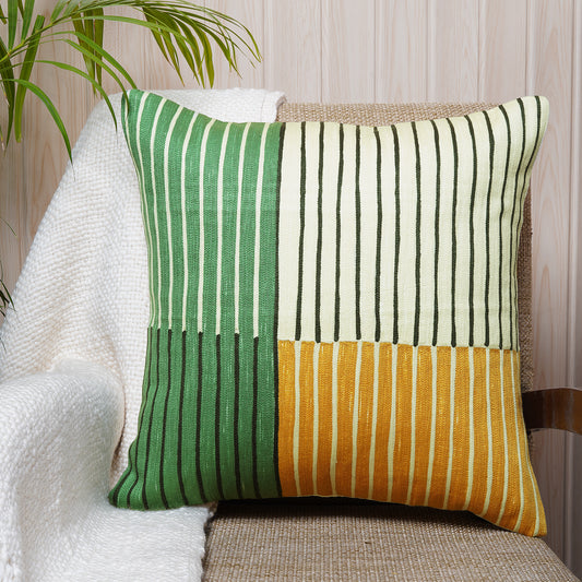 Colour-block cushion with green, cream, and mustard embroidered stripes on cotton fabric