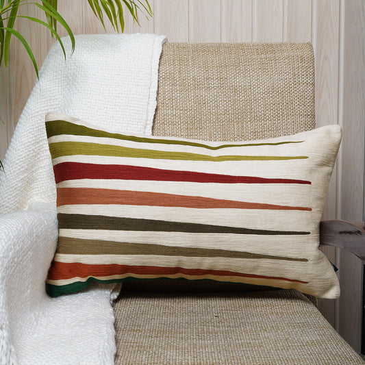 Cotton cushion in rectangular shape with abstract, colorful embroidered stripes on beige base