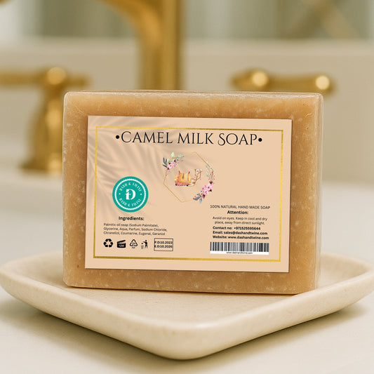 Camel Milk handmade beige soap bar with printed label, wrapped in clear packaging and placed on a white countertop with soft background