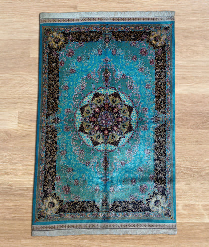 Blue Persian silk carpet with intricate medallion and floral motifs, premium traditional design