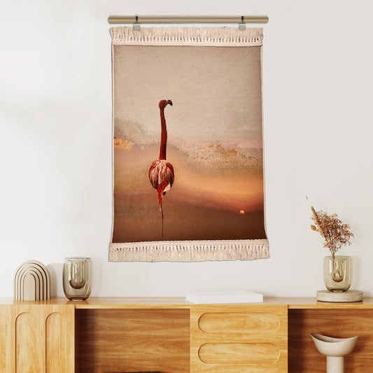 Artistic flamingo wall tapestry in warm sunset tones with fringed edges, ideal for modern living spaces